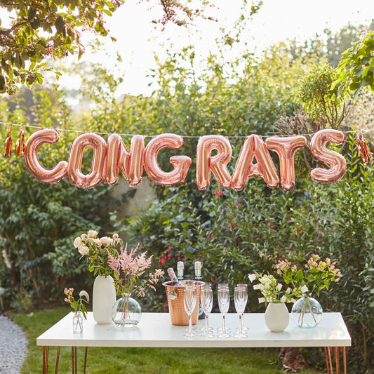 rose gold congrats balloon banner, engagement celebration decor, anniversary party balloon letters, rose gold foil balloons, festive congratulations banner, celebratory balloon decorations, milestone party banner, easy-to-assemble balloon decor, party decorations with tassels, foil balloon banner for events, elegant congratulations party decor, stylish engagement party decorations, rose gold party decor Australia, event banner with balloons, congratulatory message banner, anniversary decor, engagement party