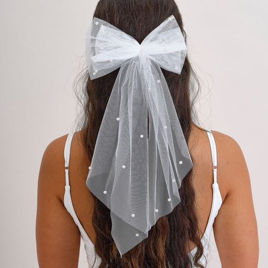 white pearl hair bow, bridal hair accessory, tulle hair bow for bride, hen party hair clip, pearl embellished bow, white wedding hair bow, elegant bride hair accessory, bride to be tulle bow, long white bridal bow, bachelorette hair clip Australia, bride pearl hair accessory, subtle bride party wear, bridal shower hair bow, hen night hair accessory, tulle and pearl bow clip, white bow for bride, DIY bride hairstyle accessory, bridal hair decorations Australia, stylish bride hair bow, soft wedding hairpiece
