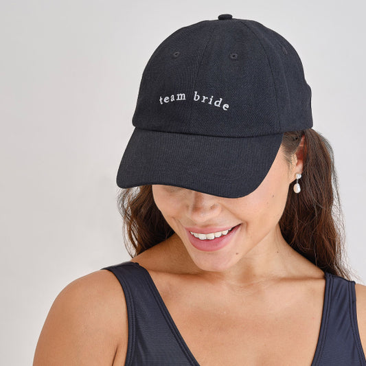 bride cap, white hen party cap, embroidered bride hat, bridal party accessories, black embroidered bride cap, wedding hat Australia, bachelorette hat, bride baseball cap, stylish bride cap, modern bridal accessories, wedding day accessories, hen do cap, bride embroidered hat, one size bride hat, white cap for bride, bride party wear, wedding prep accessories, bride cap lightweight, bride hat photo prop, hen party essentials Australia